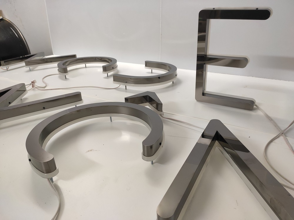 Stainless steel 3D LED letters with halo (echo) illumination ready for shop sign installation in the UK