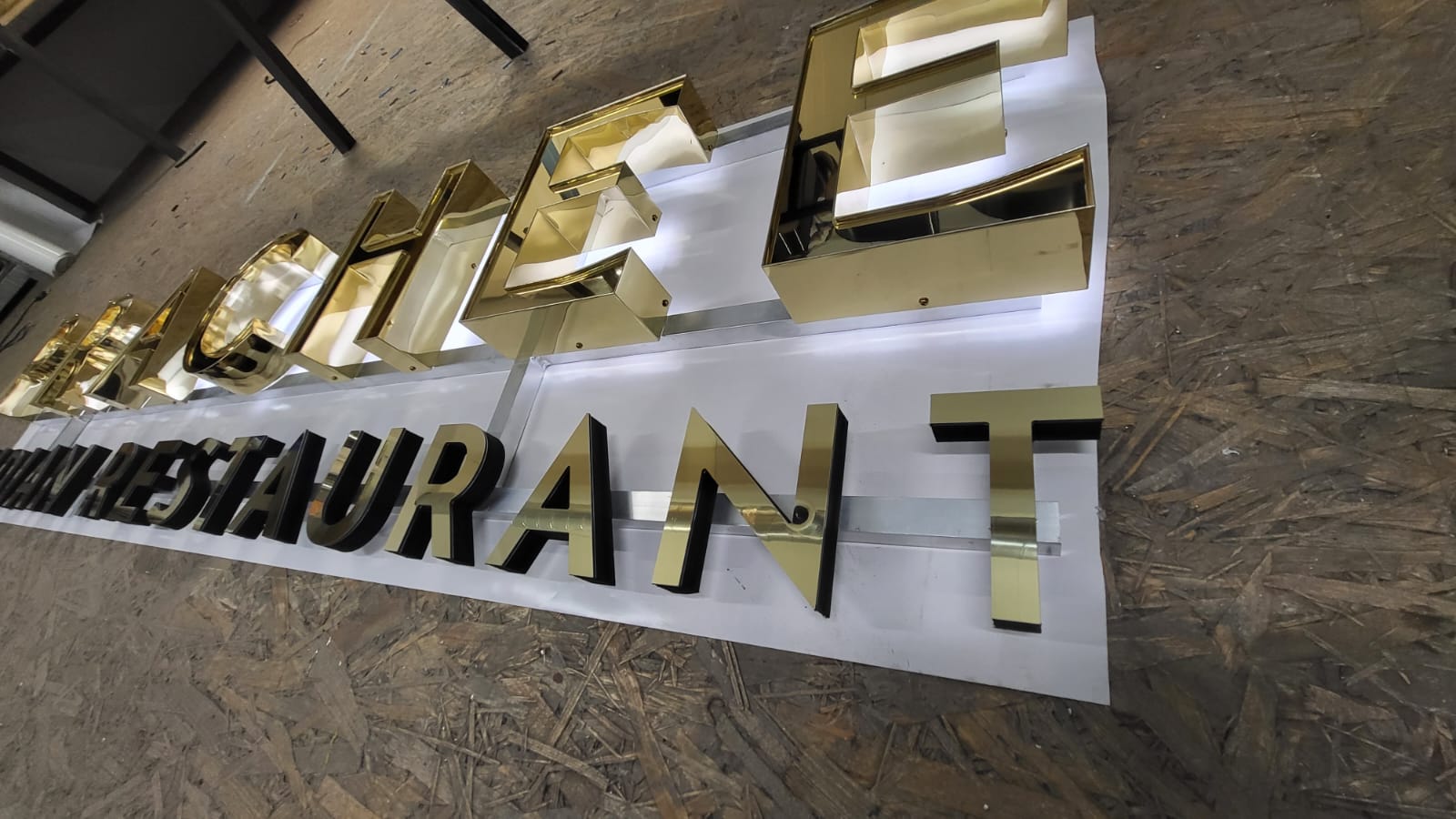 Gold front lit built up 3D LED letters in stainless steel above an Italian restaurant entrance